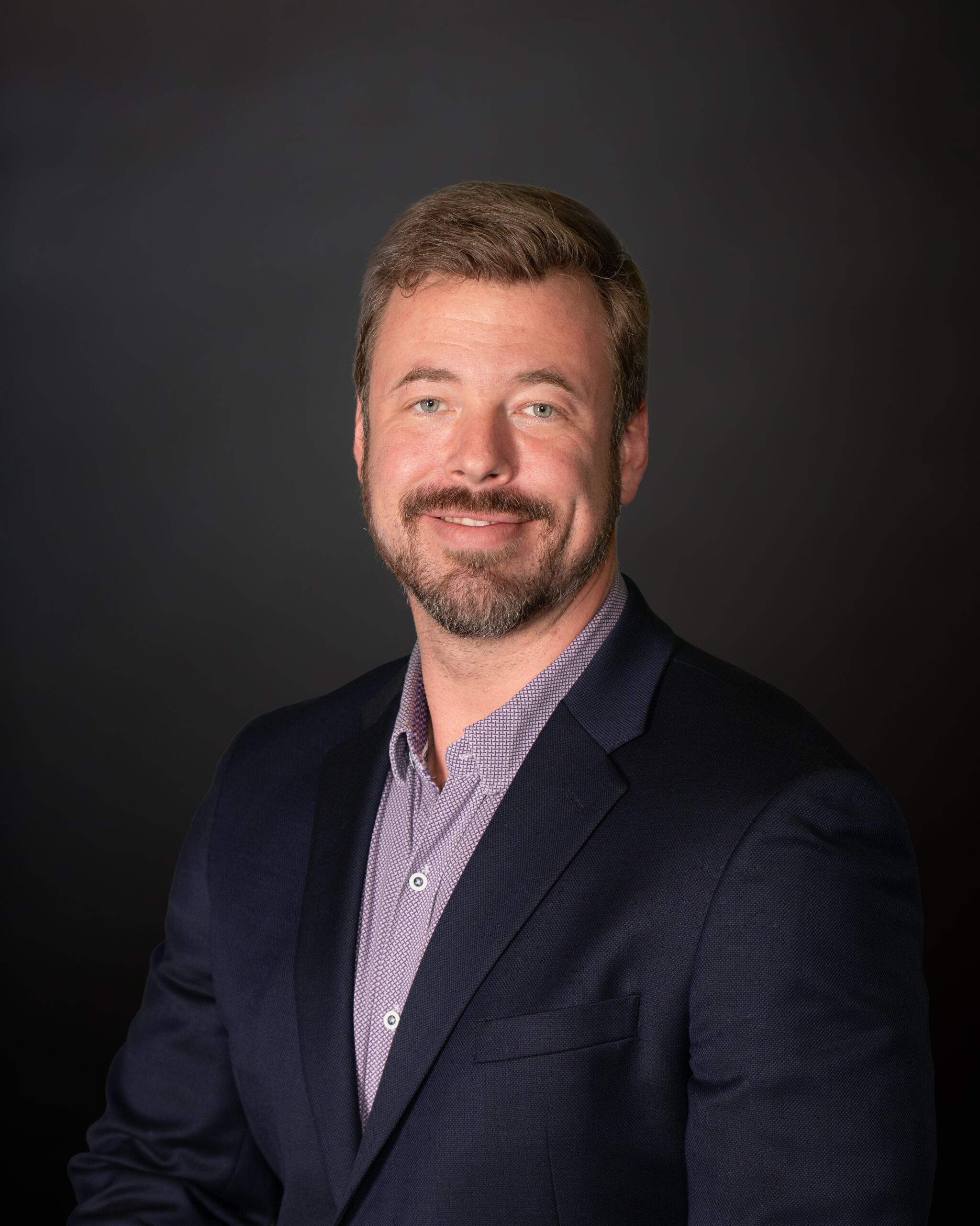 Professional headshot of Jeffrey Kuehn, CTO and technology leader specializing in AI, cybersecurity, and federal digital transformation.